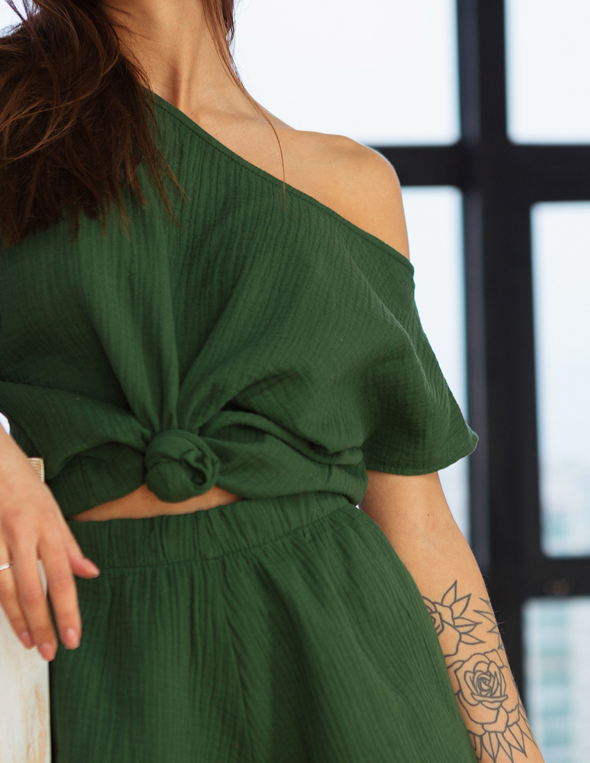 Green muslin T-shirt with an asymmetrical neckline